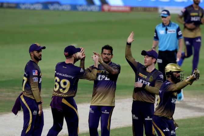 Sunil Narine celebrates with his Kolkata Knight Riders teammates after dismissing Royal Challengers Bangalore's Glenn Maxwell during the Indian Premier League 'Eliminator', in Sharjah, on Monday.