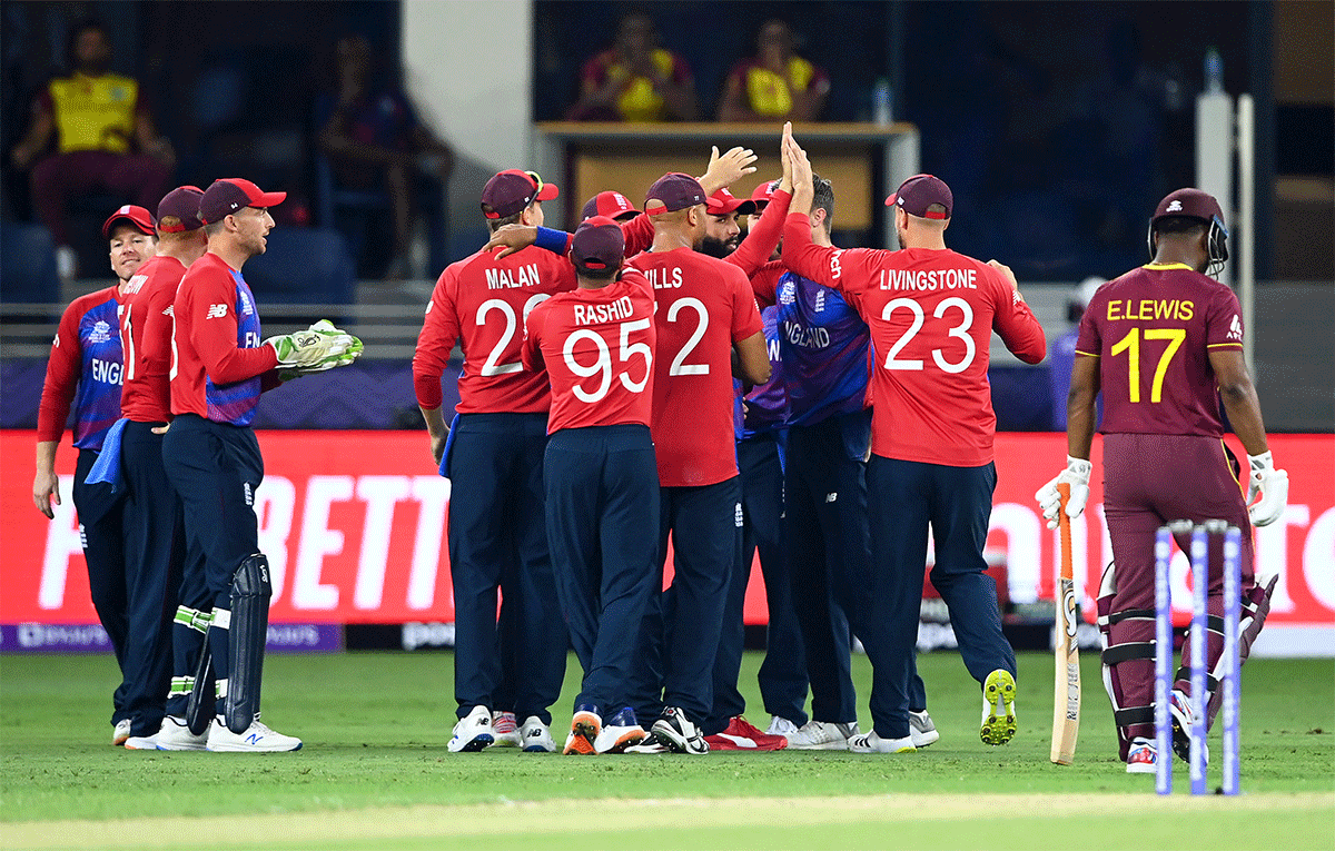 Moeen Ali celebrates with teammates after taking a catch to dismiss Evin Lewis