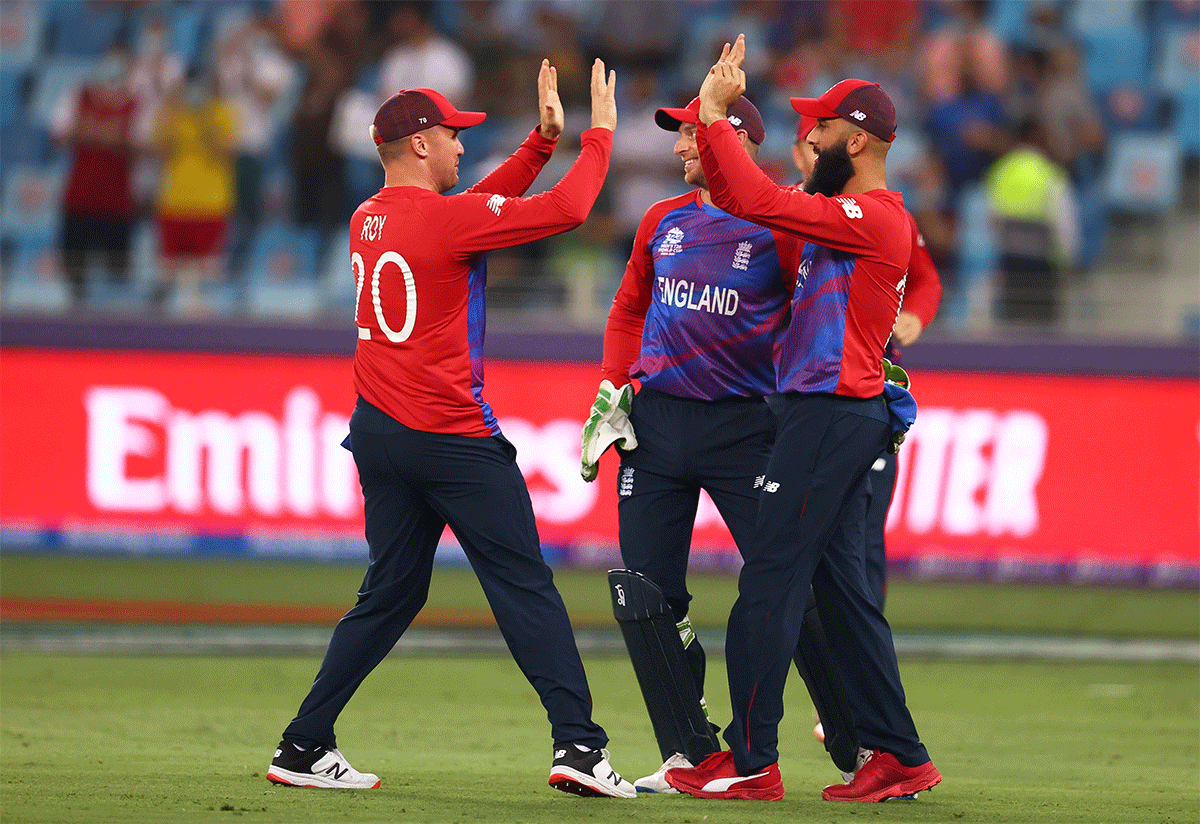 Moeen Ali celebrates with teammates after taking a catch to dismiss Evin Lewis