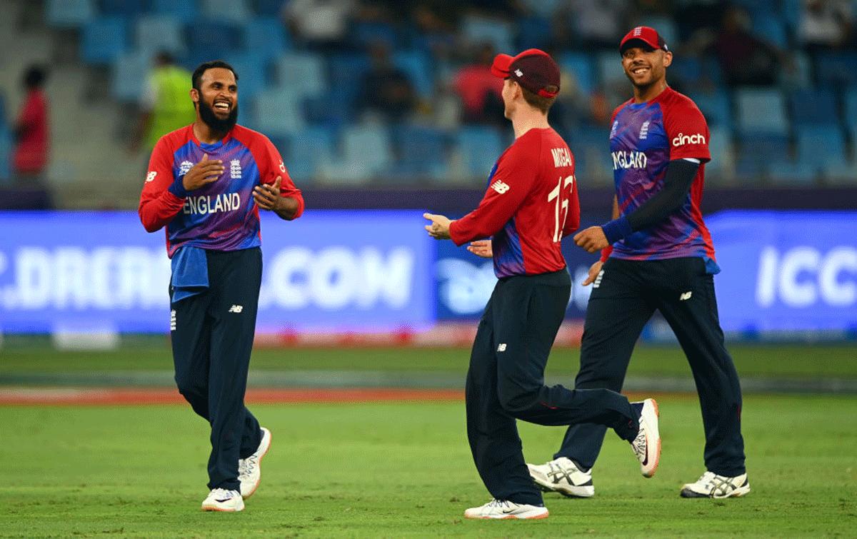 Adil Rashid celebrates with Eoin Morgan and Tymal Mills after dismissing Obed McCoy