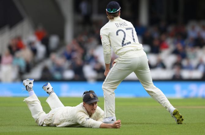 England skipper Joe Root, at first slip, fails to hold on to a catch from India skipper Virat Kohli, off the bowling of Chris Woakes. 