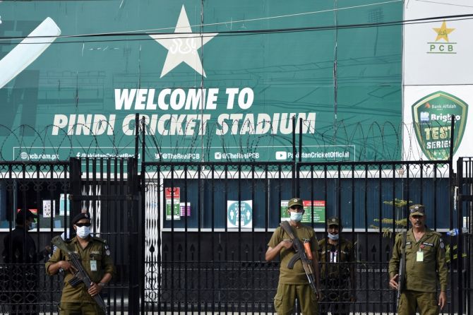 Police officers stand guard outside Rawalpindi Cricket Stadium after the New Zealand cricket team pulled out of its tour of Pakistan over security concerns. 
