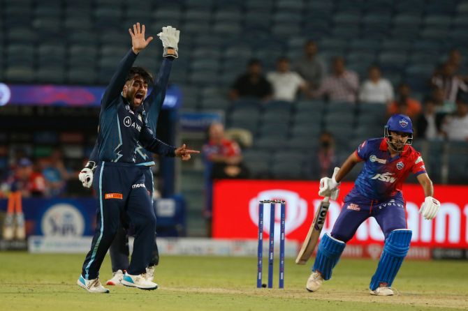 Gujarat Titans spinner Rashid Khan successfully appeals for the wicket of Delhi Capitals batter Shardul Thakur during the Indian Premier League match, at the Maharashtra Cricket Association in Pune, on Saturday.
