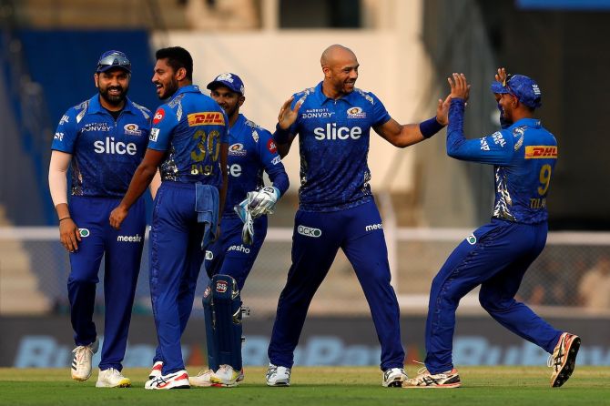Tymal Mills celebrates the wicket of Delhi Capitals' Rishabh Pant with his Mumbai Indians teammates during the IPL match at the Brabourne Stadium in Mumbai on March 27, 2022.