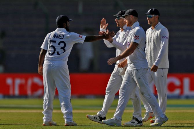 England's Rehan Ahmed celebrates with captain Ben Stokes and Jack Leach.