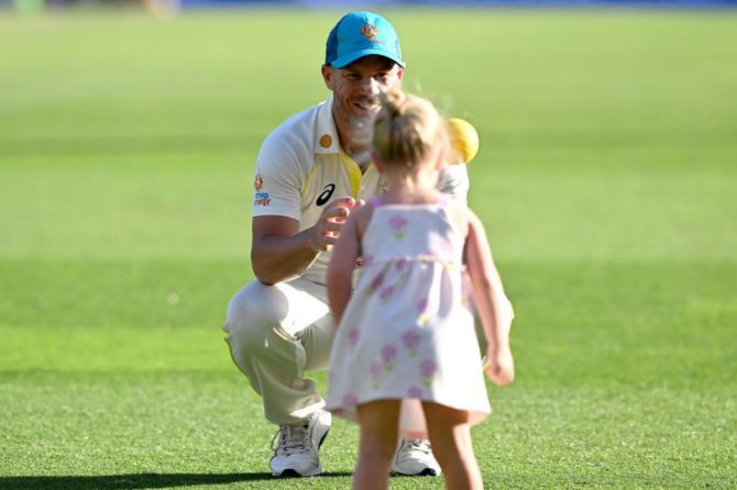 David Warner of Australia is seen playing with his daughter after day two of the First Test match between Australia and South Africa at The Gabba