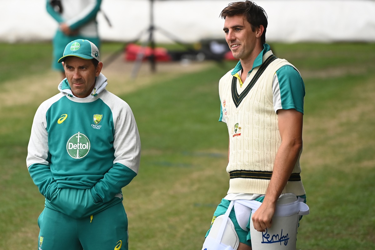 Australia captain Pat Cummins chats with Head Coach Justin Langer during an Ashes squad nets session at Blundstone Arena, in Hobart, on January 12, 2022. 