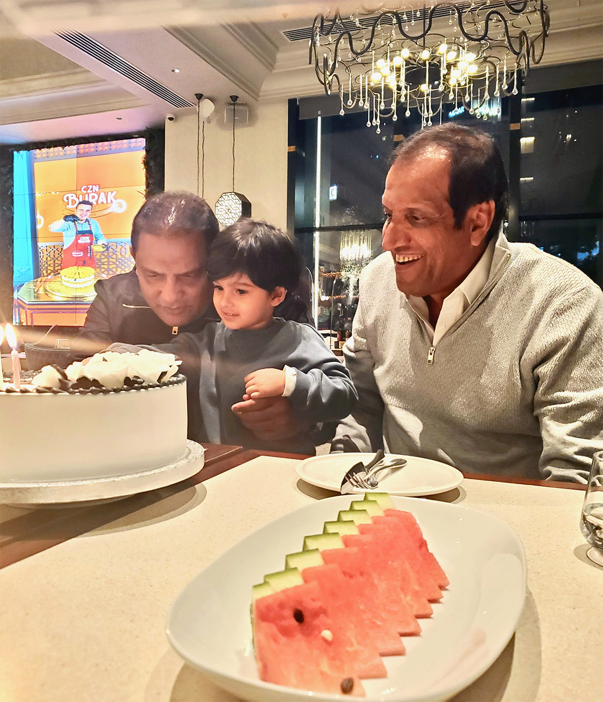 Sania Mirza's son Izhaan Mirza Malik helps Mohammed Azharuddin cut his birthday cake as Imran Mirza looks on