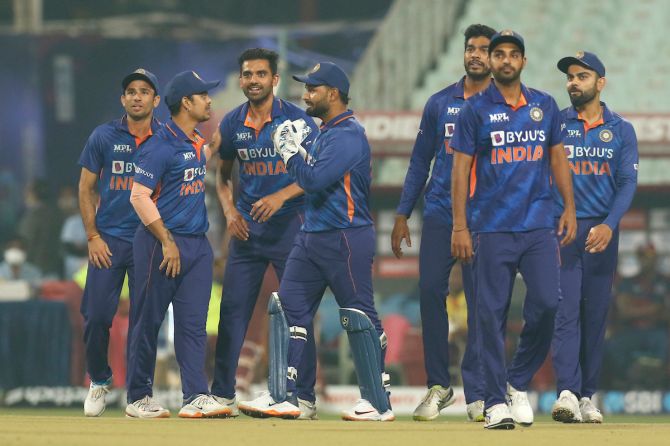 Deepak Chahar celebrates with teammates after dismissing Akeal Hosein caught and bowled.