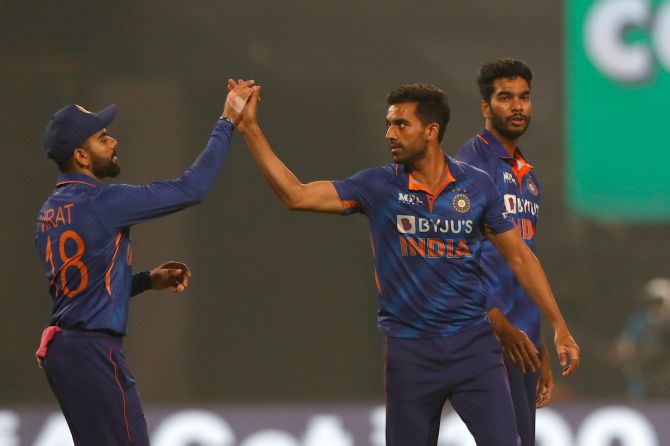 Venkatesh Iyer watches as India pacer Deepak Chahar celebrates the wicket of Nicholas Pooran with Virat Kohli during the first T20I against the West Indies at the Eden Gardens in Kolkata on Wednesday.