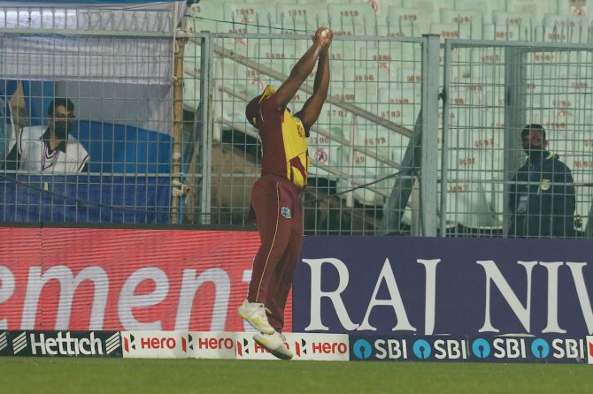 Odean Smith takes the catch to dismiss Rohit Sharma.