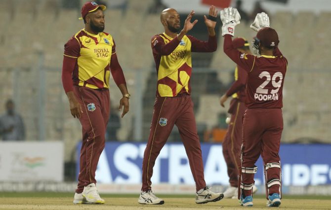 Roston Chase celebrates with his West Indies teammates after dismissing Suryakumar Yadav.