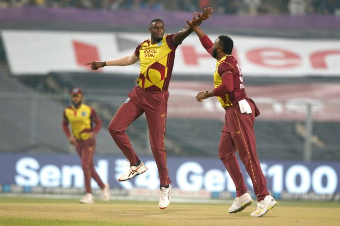 West Indies pacer Jason Holder celebrates with skipper Kieron Pollard after dismissing India opener Ruturaj Gaikwad.