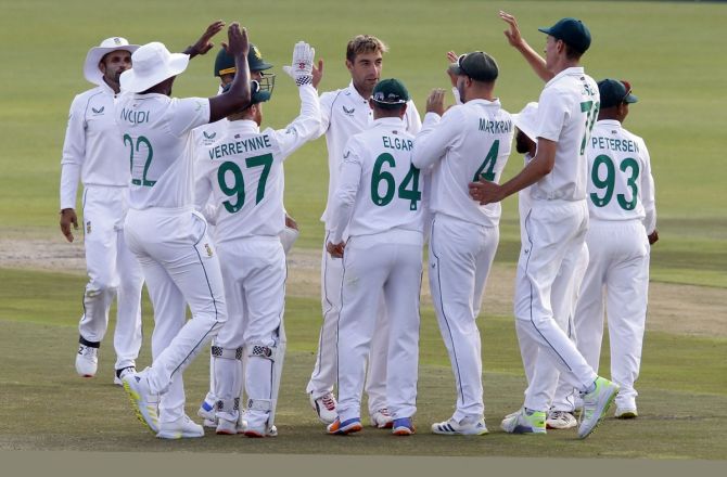 South Africa's Duanne Olivier is congratulated by teammates after dismissing India opener Mayank Agarwal in the second innings during Day 2 of the second Test, in Johannesburg, on Tuesday. 