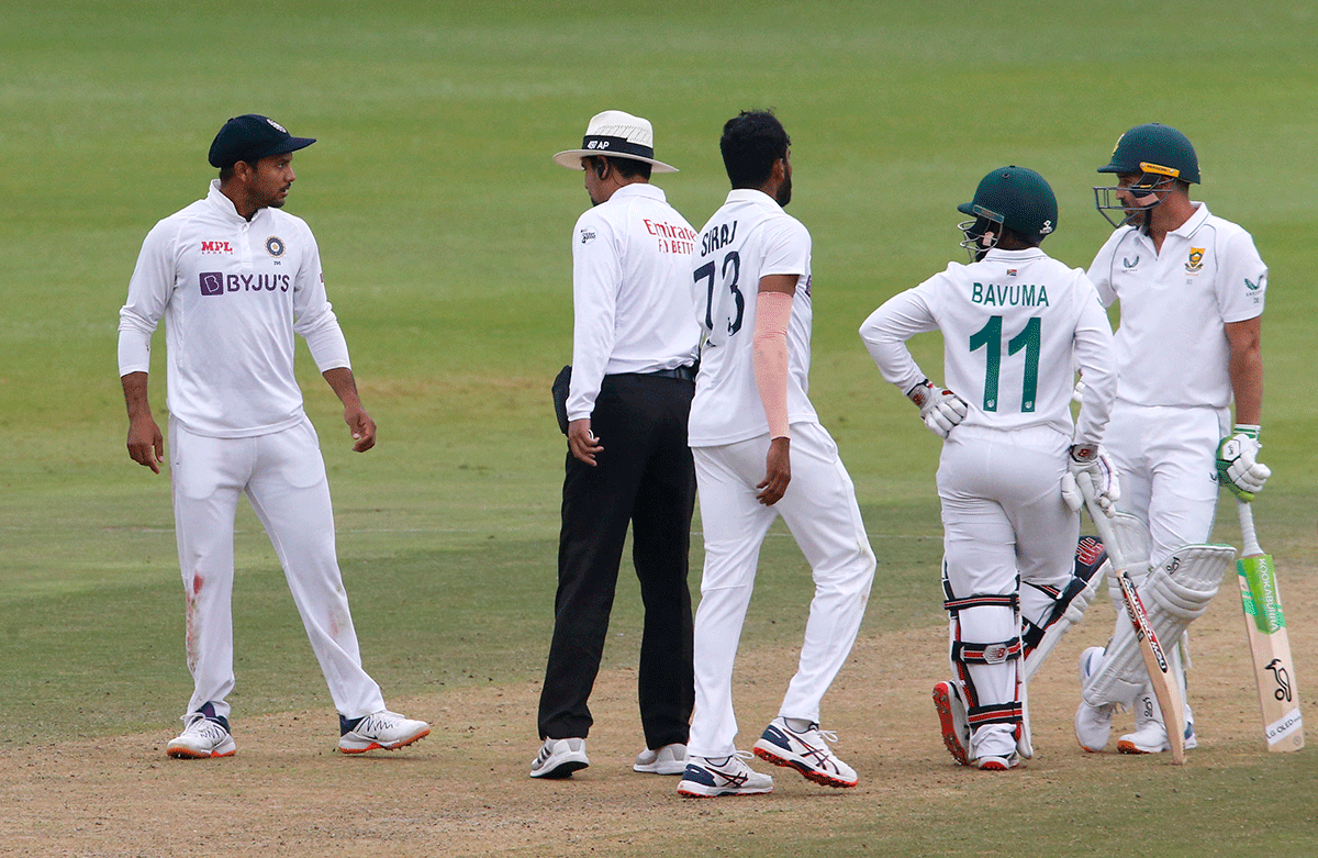 India's Mayank Agarwal exchanges words with South Africa's Dean Elgar and Temba Bavuma as the umpire intervenes 
