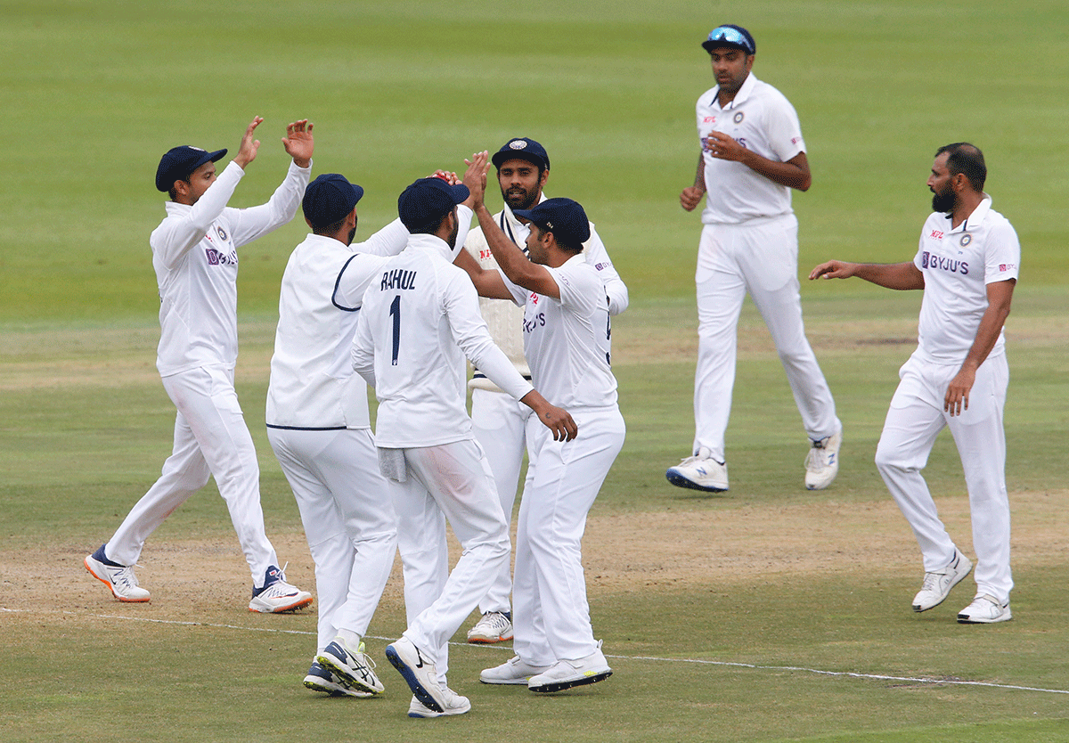 India's Mohammed Shami celebrates with teammates after taking the wicket of South Africa's Rassie van der Dussen