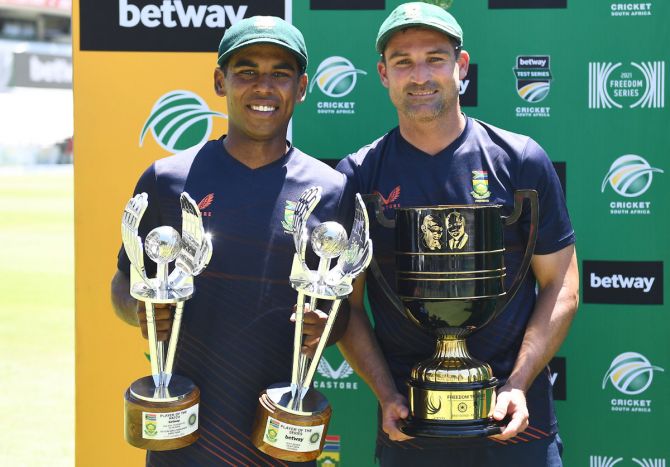 South Africa's Keegan Petersen poses with the Man of the Match and Series trophies with skipper Dean Elgar, with the Freedom trophy, after the third WTC Test against India at Newlands, Cape Town, on Friday.
