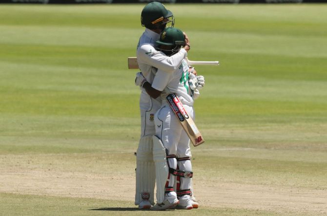 Rassie van der Dussen and Temba Bavuma celebrate after scoring the winning runs for South Africa in the third and final Test against India, in Cape Town, on Friday. 