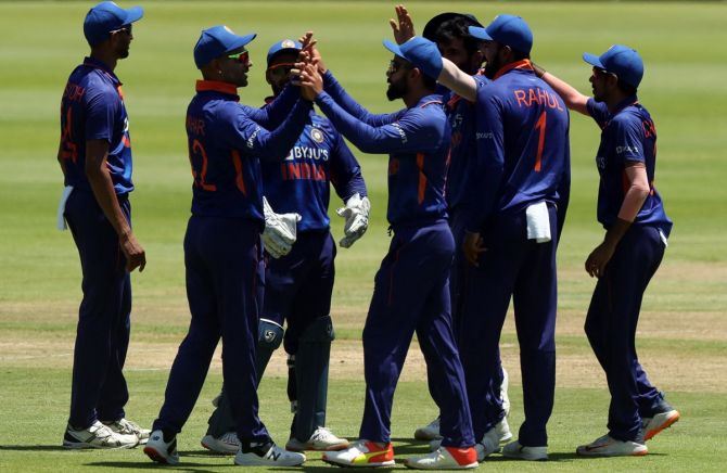 India's players celebrate the fall of a wicket
