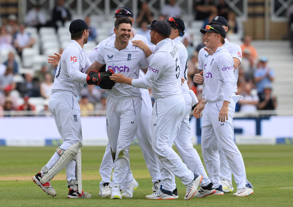 England's James Anderson celebrates with teammates after taking the wicket of New Zealand's Devon Conway