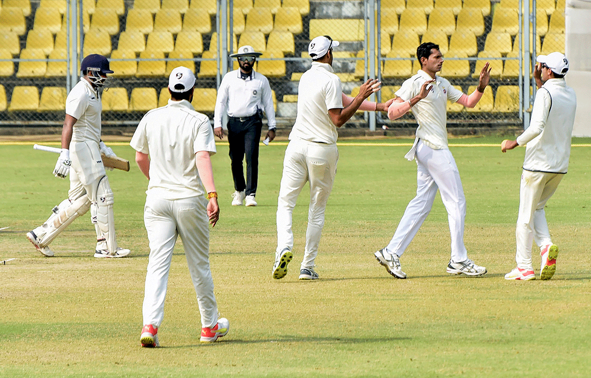 Delhi bowler Navdeep Saini celebrates along with teammates after taking a wicket on Day 1 of the Ranji Trophy cricket match against Chhattisgarh, in Guwahati on Thursday