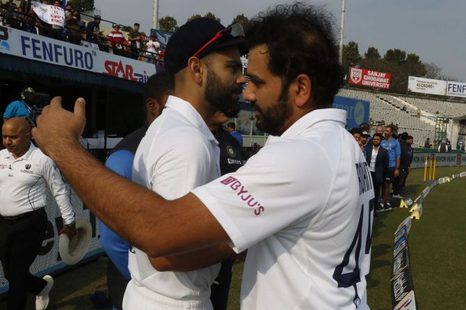 Virat Kohli is congratulated by India skipper Rohit Sharma on his 100th Test milestone.