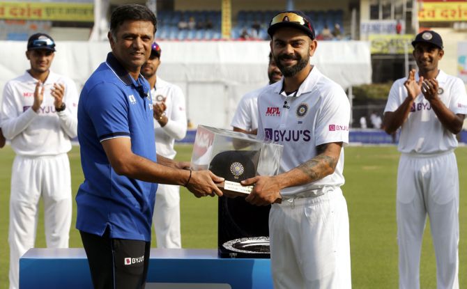 India head coach Rahul Dravid presents Virat Kohli a special cap on his 100th Test before the start of play on Day 1 of the first Test against Sri Lanka, at Mohali, on Friday.