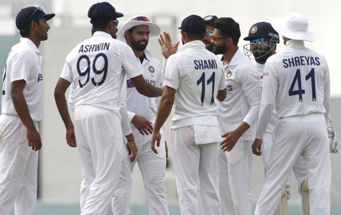 Ravindra Jadeja celebrates with teammates after taking the wicket of Suranga Lakmal.