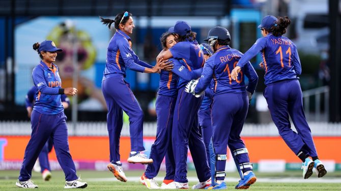 Sneh Rana celebrates with her India teammates after taking the wicket of Hayley Matthews.