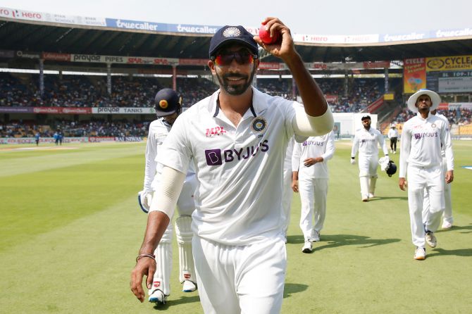 India pacer Jasprit Bumrah displays the ball as he walks back  after taking five wickets in Sri Lanka's first innings on Day 2 of the second Test, at the M Chinnaswamy Stadium, in Bengaluru, on Sunday.