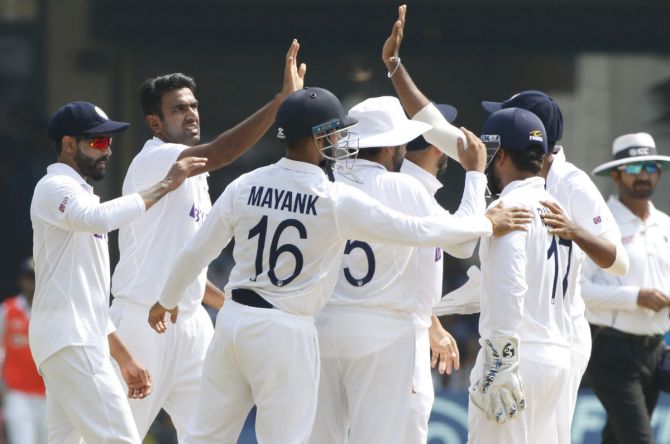 India spinner Ravichandran Ashwin celebrates with teammates after dismissing Sri Lanka's Kusal Mendis in the second innings on Day 3 of the second Test, in Bengaluru, on Monday.