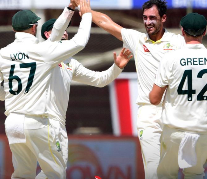 Australia pacer Mitchell Starc celebrates with teammates after dismissing Pakistan’s Fawad Alam on Day 3 of the second Test in Karachi on Monday. 