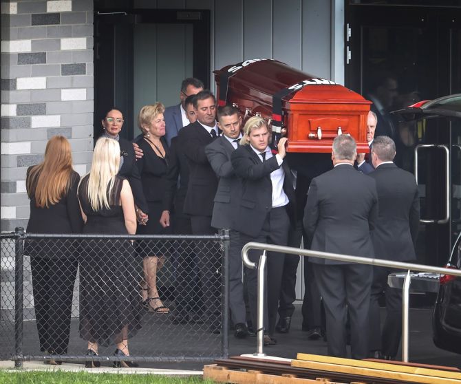 Family and friends carry the coffin of Australia cricket legend Shane Warne during the funeral service at St Kilda Football Club in Melbourne, Australia, on Sunday. 
