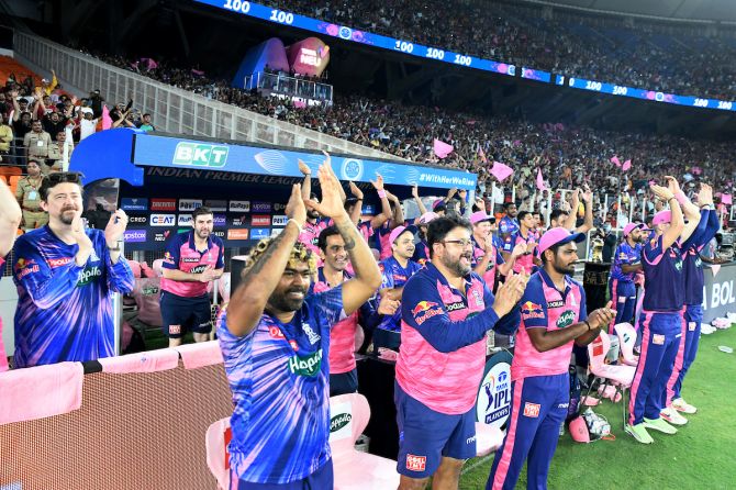Rajasthan Royals fast bowling coach Lasith Malinga, Siddhartha Lahiri, Head Coach of Rajasthan Royals Cricket Academy, UK, and skipper Sanju Samson celebrate after Jos Buttler registers his fourth century in IPL 2022 in Qualifier 2 against Royal Challengers Bangalore, in Ahmedabad, on Friday.