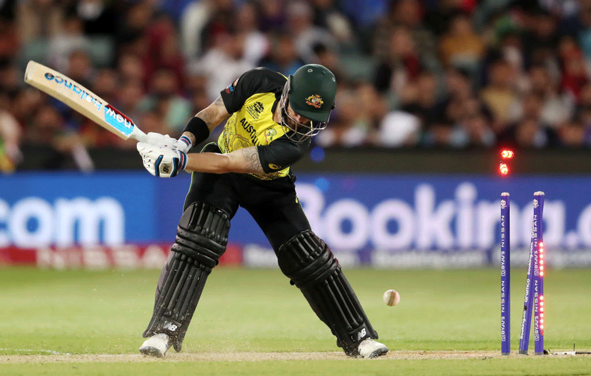 Australia's Matthew Wade is bowled by Afghanistan's Fazalhaq Farooqi 