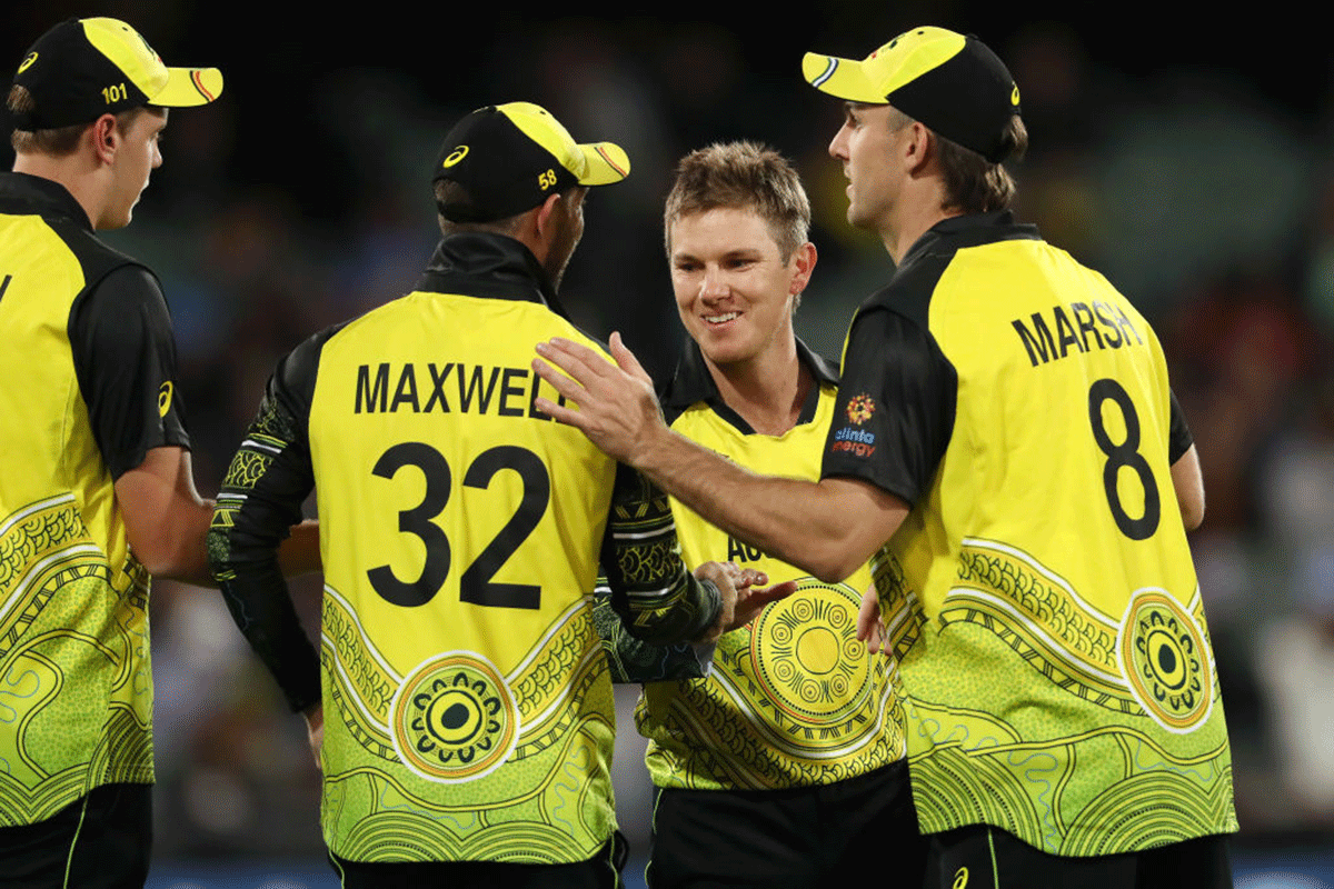 Australia's Adam Zampa celebrates with Glenn Maxwell after they combined to run out Afghanistan's Najib Zadran at Adelaide Oval in Adelaide on Friday