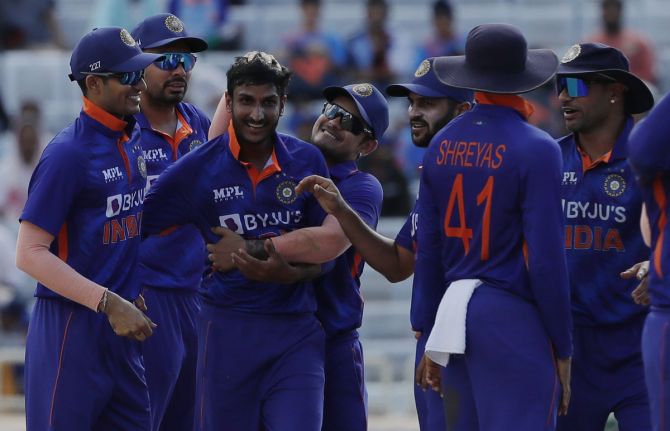 India's players celebrate after Shahbaz Ahmed, centre, claimed the wicket of Janneman Malan