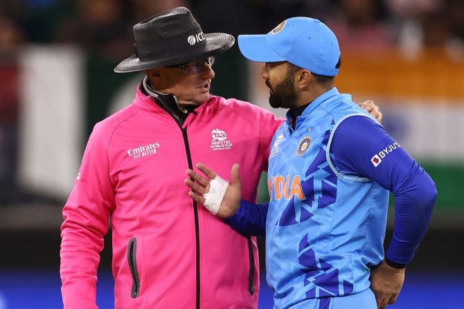 Dinesh Karthik of India talks with Umpire Richard Kettleborough before leaving the field with an injury