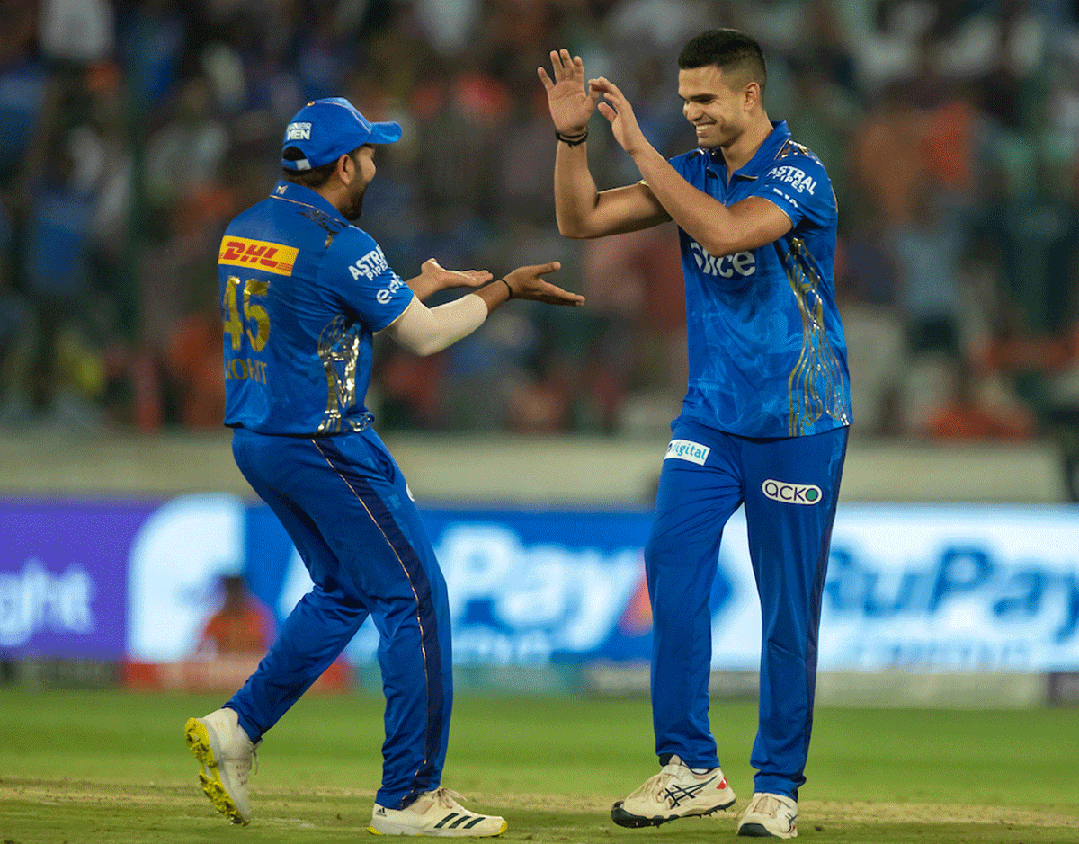 Rohit Sharma and Arjun Tendulkar celebrate the wicket of Bhuvneshwar Kumar