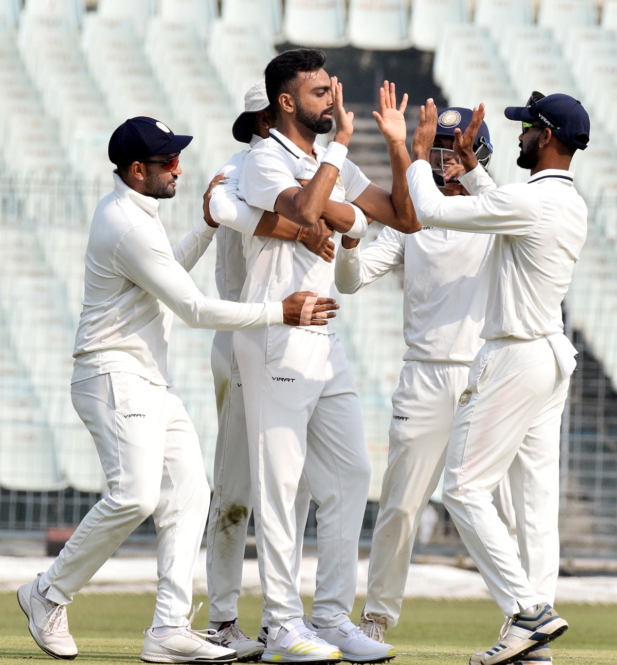 Saurashtra pacer Jaydev Unadkat celebrates with teammates after dismissing Bengal opener Abhimanyu Easwaran for a duck early on Day 1 of the Ranji Trophy final, at the Eden Gardens, in Kolkata, on Thursday. 