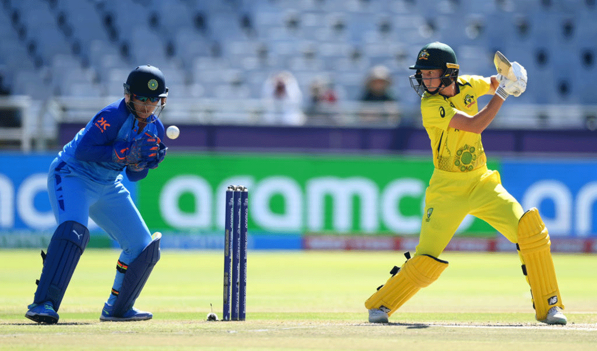 Meg Lanning plays a shot as India's Richa Ghosh watches