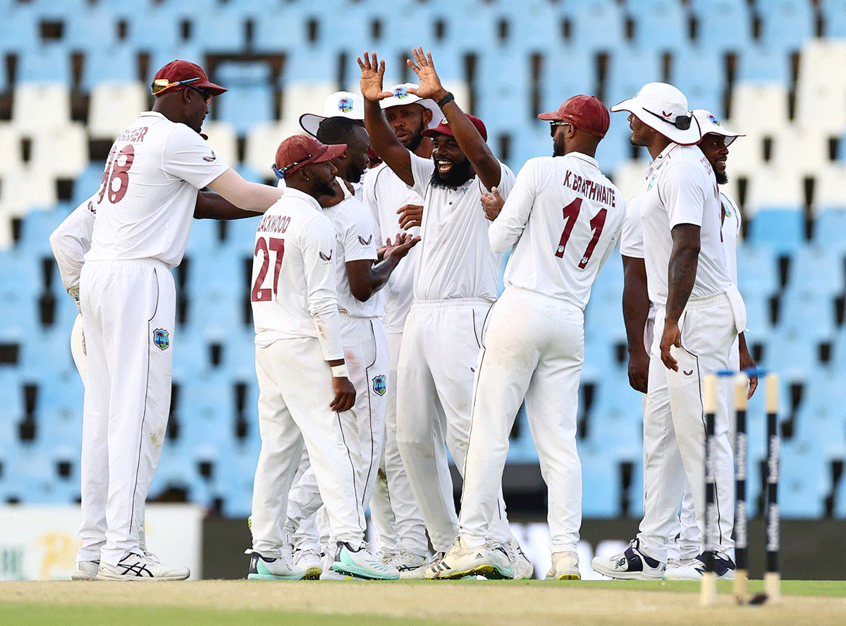 West Indies' Kemar Roach celebrates with teammates after taking the wicket of South Africa's Senuran Muthusamy