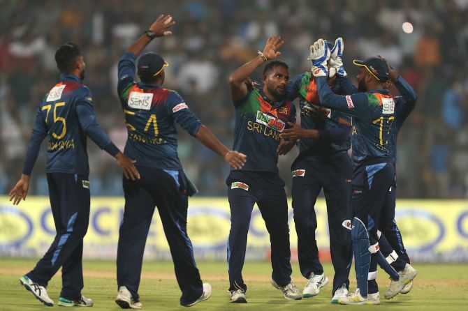 Chamika Karunaratne celebrates with his Sri Lanka teammates after dismissing Suryakumar Yadav.
