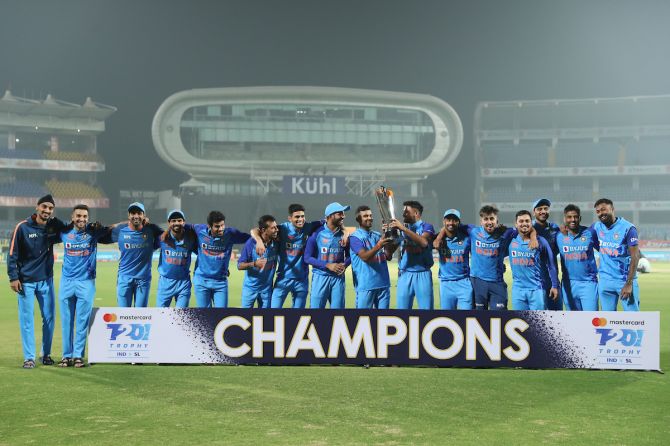 India players celebrate with the trophy after beating Sri Lanka in the third T20I and wrapping the series 2-1, at the Saurashtra Cricket Association Stadium, in Rajkot, on Saturday.