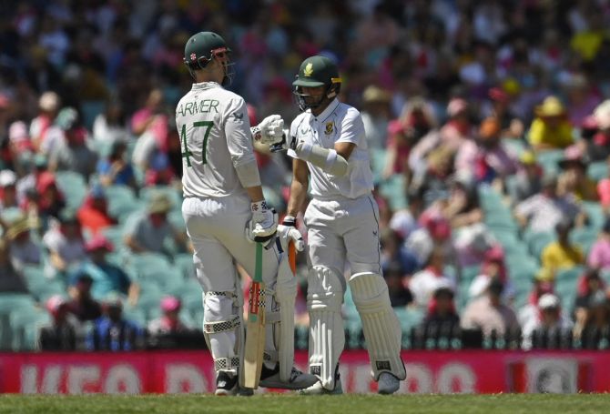Tailenders Simon Harmer (47) and Keshav Maharaj (53) bump fists during their partnership of 85 for the eighth wicket that extended South Africa's first innings.