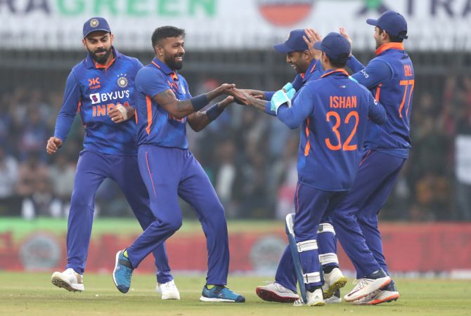 Hardik Pandya celebrates with team-mates after taking the wicket of Finn Allen.