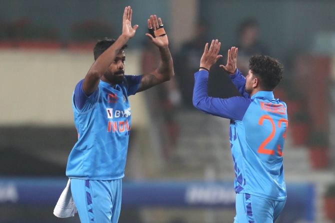 Hardik Pandya and Kuldeep Yadav celebrate the wicket of Glenn Phillips