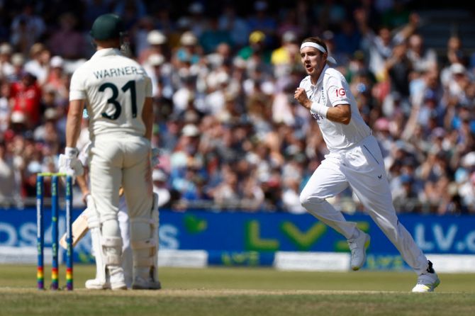 Australia's David Warner looks on as England's Stuart Broad celebrates after taking his wicket