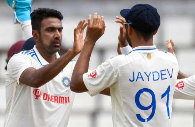 Ravichandran Ashwin celebrates with team-mates after taking the wicket of Jermaine Blackwood.