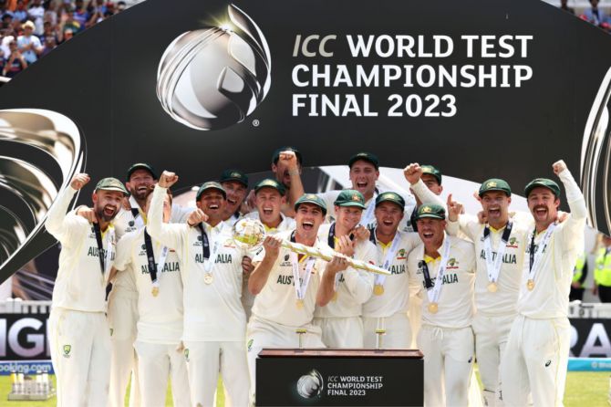 Australian players celebrate with the ICC Test mace after defeating India to win the WTC final by 209 runs at The Oval in London on Sunday
